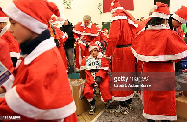 Participants dress up as Santa Claus prior to competing in the 5th annual Michendorf Santa Run on December 8, 2013 in Michendorf, Germany. Over 900...