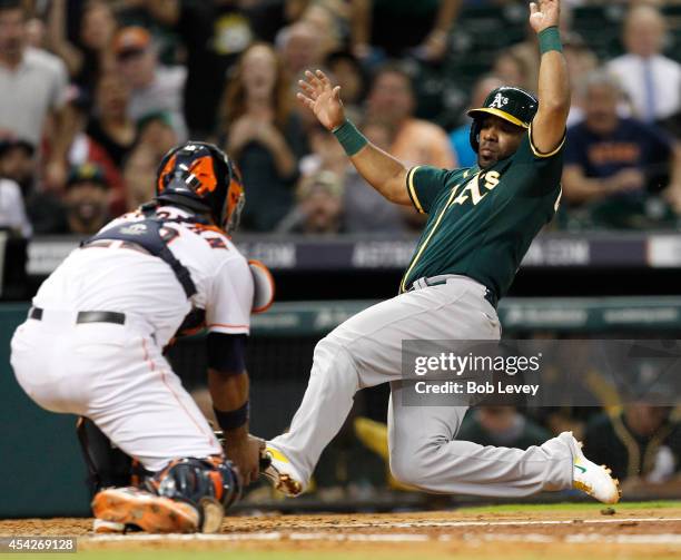 Alberto Callaspo of the Oakland Athletics is tagged out by Carlos Corporan of the Houston Astros trying to score in the fifth inning at Minute Maid...