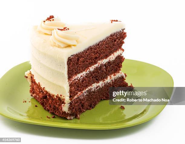 Large Slice of Red Velvet Cake served in a green plastic plate.