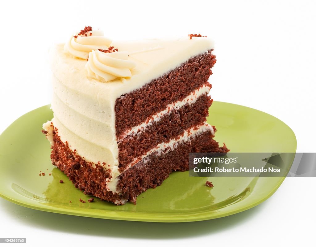 Large Slice of Red Velvet Cake served in a green plastic...