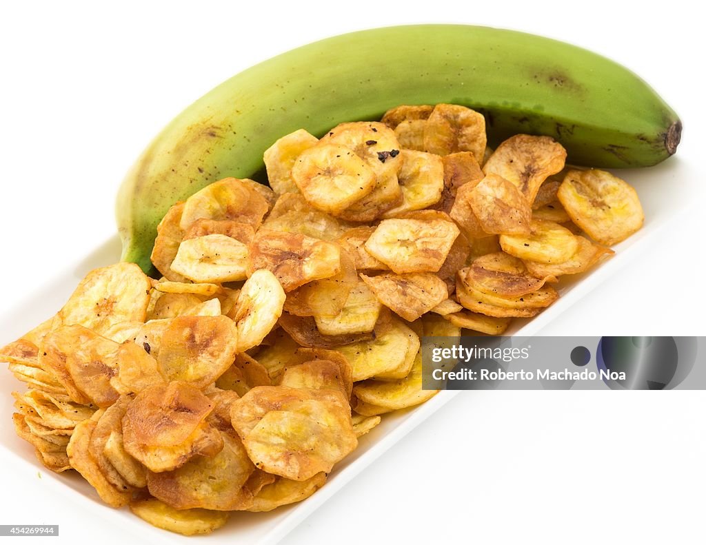 Deep fried salty green banana chips served in a white plate...