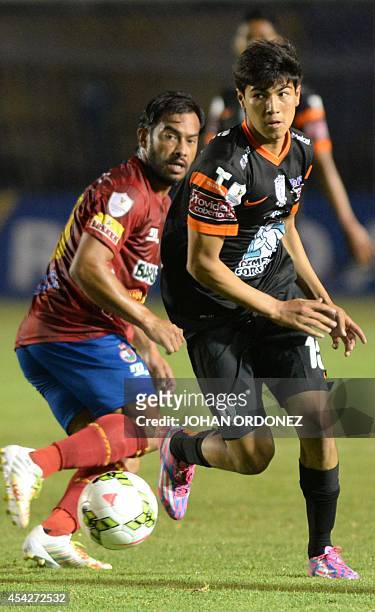 Erick Gutierrez of Mexico's Pachuca vies for the ball with Carlos Ruiz of Guatemala's Municipal during the CONCACAF Champions League football match...