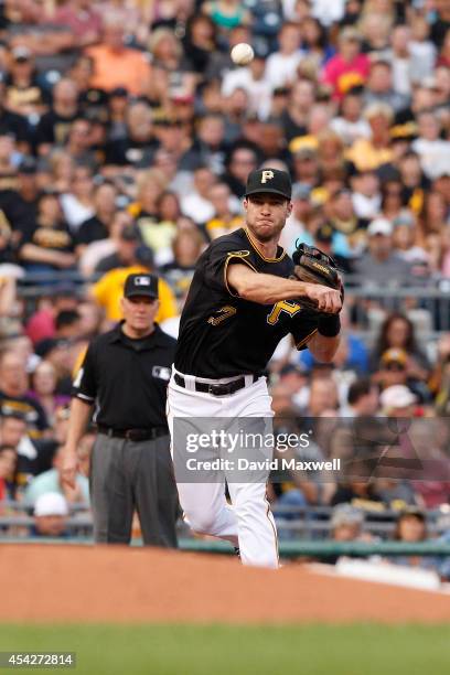 Jayson Nix of the Pittsburgh Pirates throws to first base against the San Diego Padres during the second inning of their game on August 9, 2014 at...