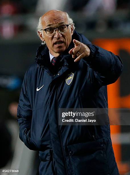 Carlos Bianchi, coach of Boca Juniors gives instructions to his players during a match between Estudiantes and Boca Juniors as part of forth round of...