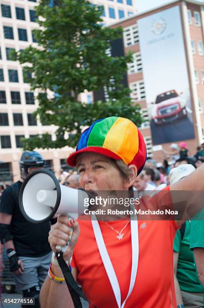 Woman wearing a rainbow cap and speaking to the crowd with megaphone during Pride Parade which is the closing activity of the Toronto Pride Festival...