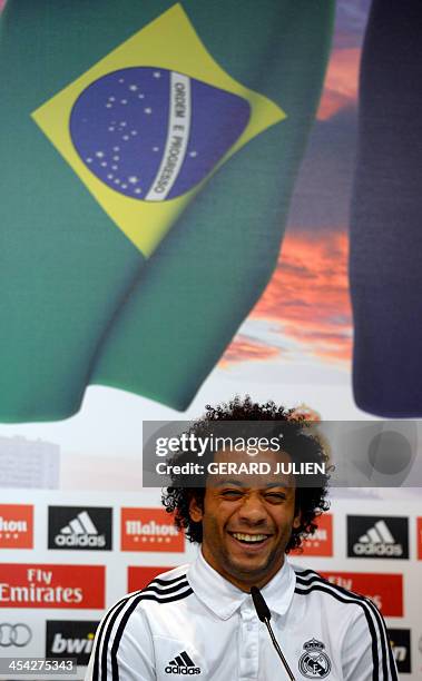 Real Madrid's Brazilian defender Marcelo laughs as he gives a press conference with his teammates to give their thoughts on 2014 World Cup draw, at...