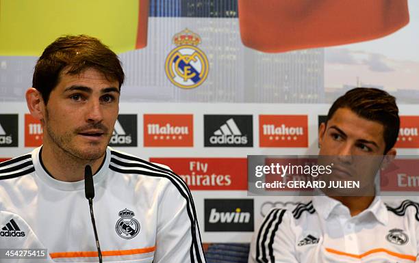 Real Madrid's Portuguese forward Cristiano Ronaldo listens to Spanish goalkeeper Iker Casillas as they give a press conference with their teammates...