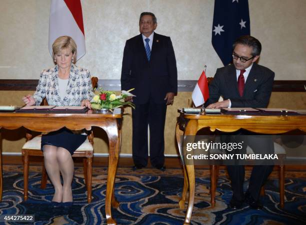 Indonesian President Susilo Bambang Yudhoyono witnesses Australian Foreign Minister Julie Bishop and her Indonesian counterpart Marty Natalegawa sign...