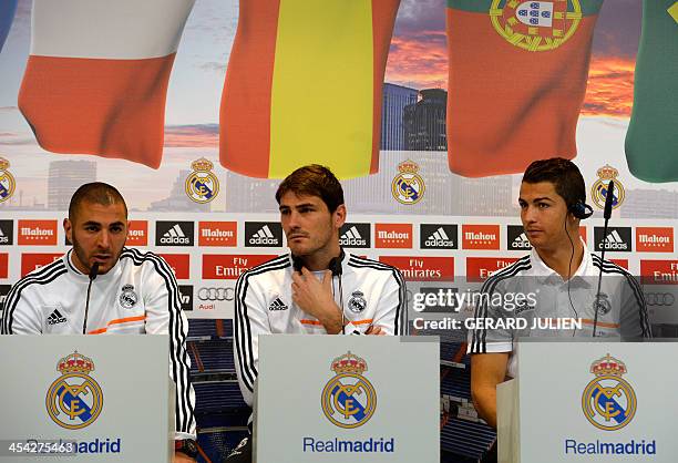 Real Madrid's Portuguese forward Cristiano Ronaldo and Spanish goalkeeper Iker Casillas listen to French forward Karim Benzema as they give a press...