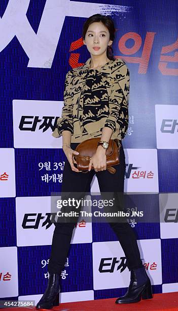 Lee Chung-Ah poses for photographs during the movie "Tazza: The High Rollers 2" VIP premiere at Geondae Lotte Cinema on August 25, 2014 in Seoul,...