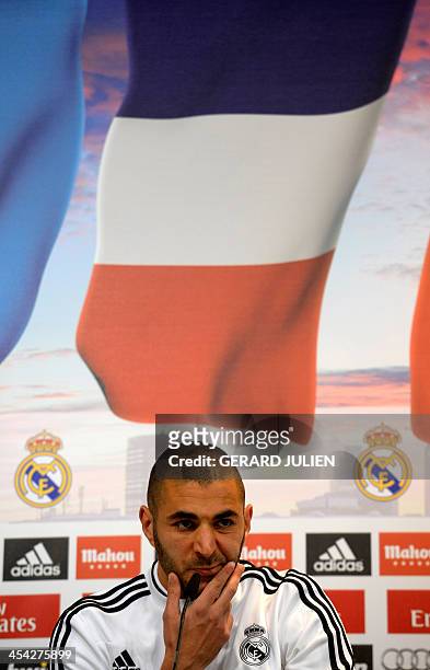 Real Madrid's French forward Karim Benzema reacts as he gives a press conference with his teammates to give their thoughts on 2014 World Cup draw, at...