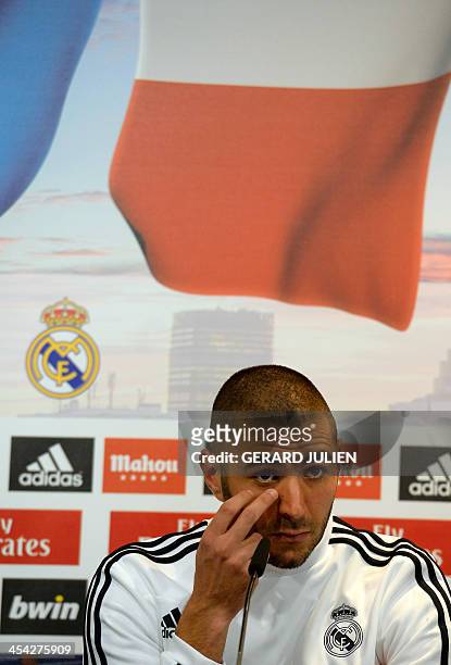 Real Madrid's French forward Karim Benzema gestures as he gives a press conference with his teammates to give their thoughts on 2014 World Cup draw,...