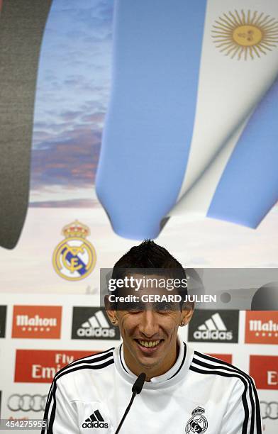 Real Madrid's Argentinian midfielder Angel di Maria smiles as he gives a press conference with his teammates to give their thoughts on 2014 World Cup...