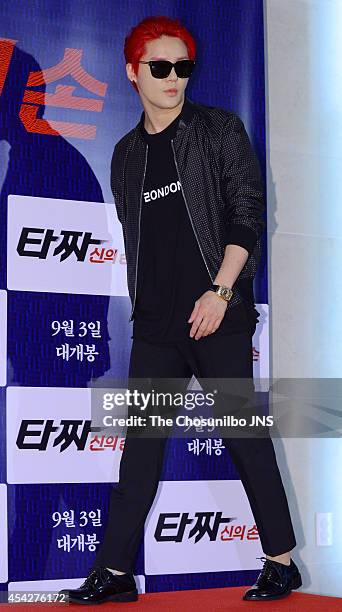 Kim Jun-Su of JYJ poses for photographs during the movie "Tazza: The High Rollers 2" VIP premiere at Geondae Lotte Cinema on August 25, 2014 in...