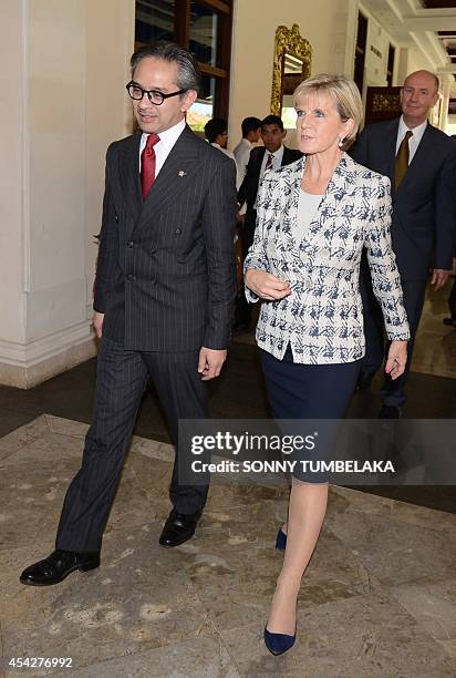 Australia's Foreign Minister Julie Bishop walks with her Indonesian counterpart Marty Natalegawa after a signing ceremony in Nusa Dua on Indonesia's...