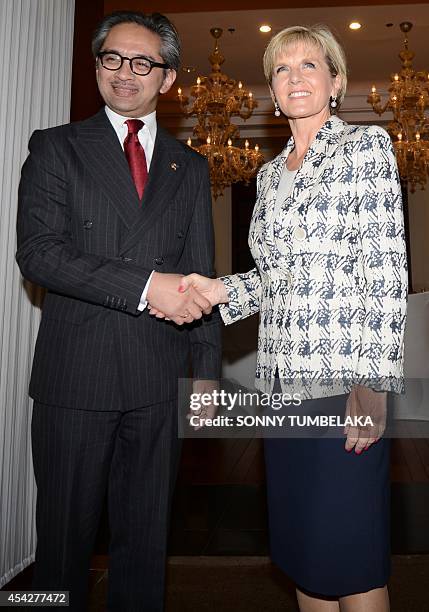 Australia's Foreign Minister Julie Bishop shakes hands with her Indonesian counterpart Marty Natalegawa before their bilateral meeting in Nusa Dua on...