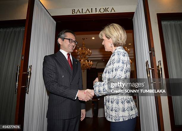 Australia's Foreign Minister Julie Bishop shakes hands with her Indonesian counterpart Marty Natalegawa before their bilateral meeting in Nusa Dua on...
