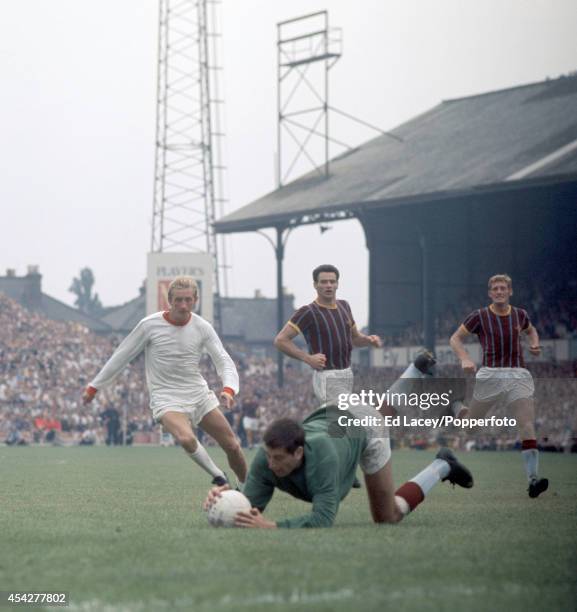 Crystal Palace goalkeeper John Jackson dives to save at the feet of Manchester United striker Denis Law during the Division One match at Selhurst...