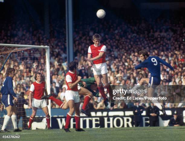 Arsenal defender John Roberts heads the ball away in front of Chelsea striker Peter Osgood during the Division One match at Stamford Bridge in London...