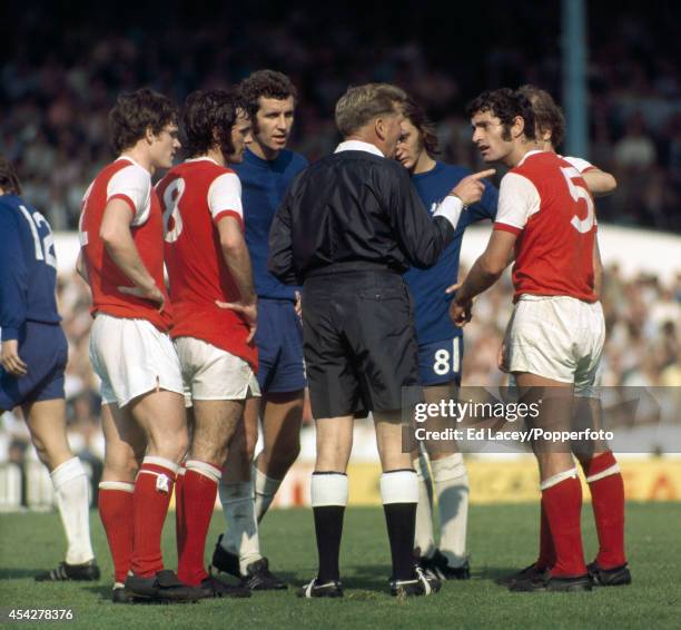 The referee lectures Frank McLintock of Arsenal about an incident involving him with Peter Osgood of Chelsea during the Division One football match...