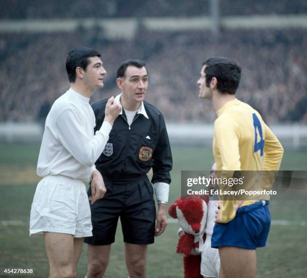 Referee Bill Handley with the team captains, Stan Harland of Swindon Town and Frank McLintock of Arsenal, prior to the League Cup Final at Wembley...