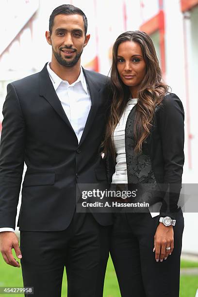 Mehdi Benatia of FC Bayern Muenchen pose with his wife Cecile Benatia after a press conference at Bayern Muenchen's headquarter Saebener Strasse on...