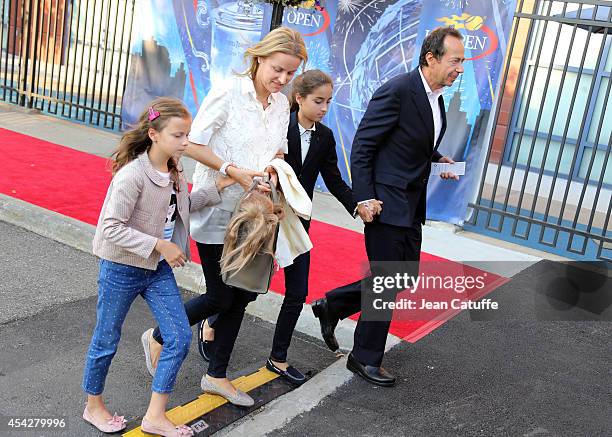 John Paulson and his family arrive at Arthur Ashe Stadium on Day 3 of the 2014 US Open at USTA Billie Jean King National Tennis Center on August 27,...
