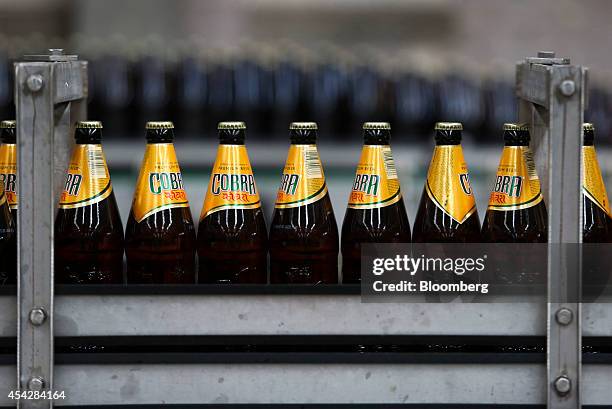 Bottles of Cobra beer, manufactured by Molson Coors Brewing Co., pass along the production line at the company's brewery and bottling plant in...