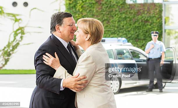 German Chancellor Angela Merkel greets European Commission President Jose Manuel Barroso upon his arrival for the German government Balkan conference...