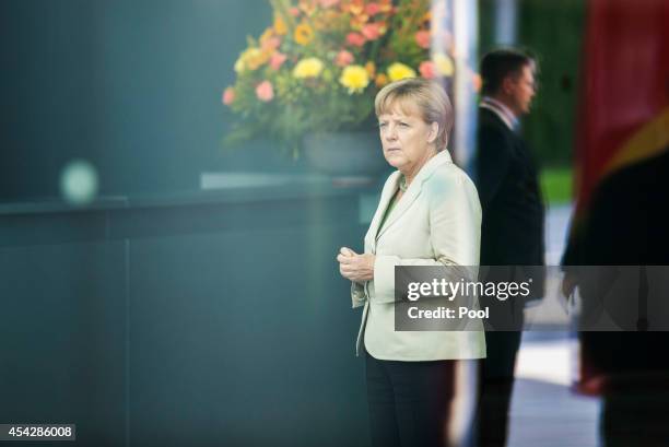 German Chancellor Angela Merkel waits for delegates at the German government Balkan conference at the Chancellery on August 28, 2014 in Berlin,...