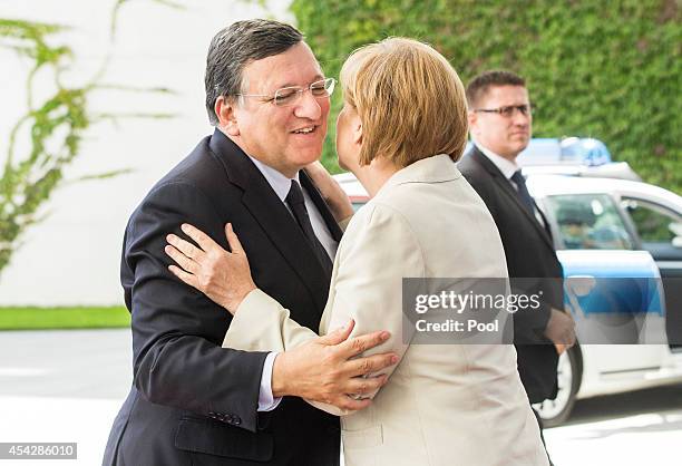 German Chancellor Angela Merkel greets European Commission President Jose Manuel Barroso upon his arrival for the German government Balkan conference...