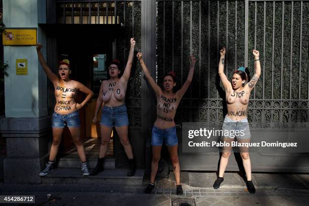 Activists protest against the recent cases of sexual violence and rapes against women, with body painting reading 'Rape = Spain Brand', 'It is not',...