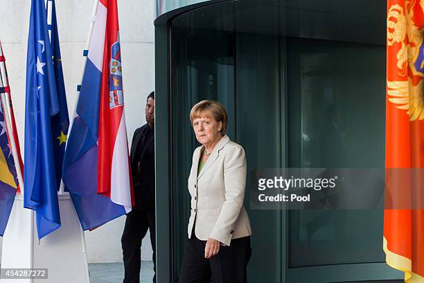 German Chancellor Angela Merkel waits for delegates at the German government Balkan conference at the Chancellery on August 28, 2014 in Berlin,...