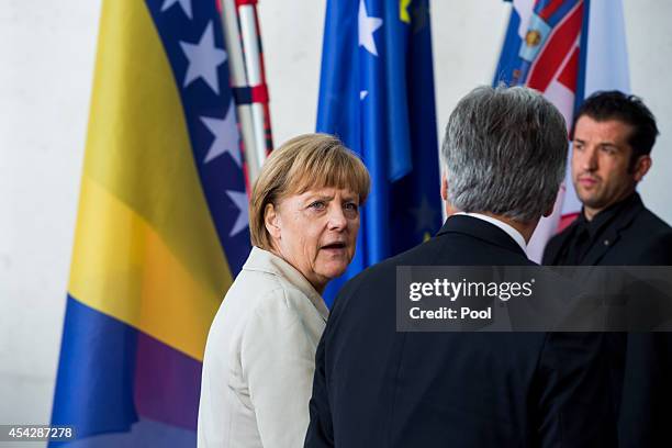 German Chancellor Angela Merkel greets Austrian Chancellor Werner Faymann upon his arrival for the German government Balkan conference at the...