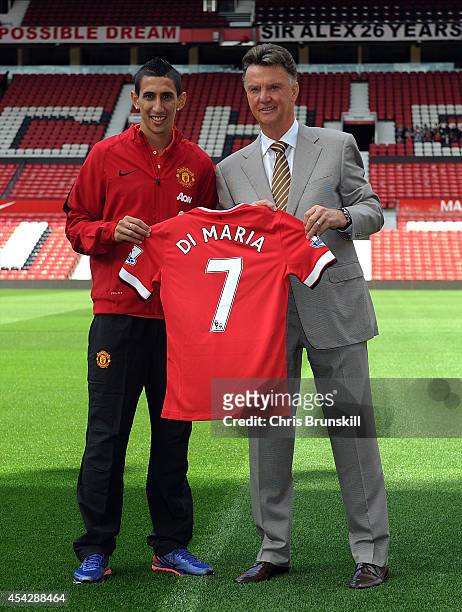 Manchester United manager Louis Van Gaal poses for a photograph next to new signing Angel Di Maria at Old Trafford on August 28, 2014 in Manchester,...