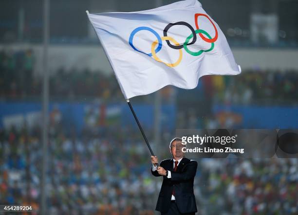 International Olympic Committee President Thomas Bach waves the Olympic flag during the Closing Ceremony of Nanjing 2014 Summer Youth Olympic Games...