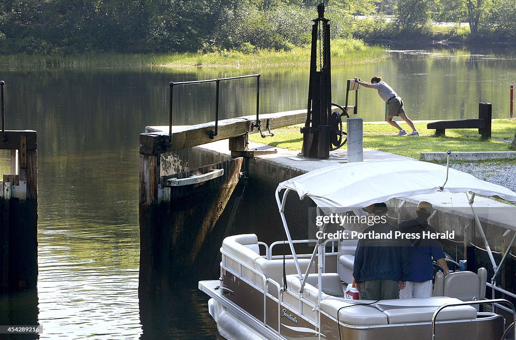 Assistant Park Ranger Lauren Hillier opens the Songo Locks for boaters...