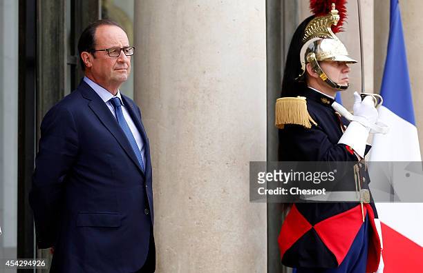 French President Francois Hollande waits before his meeting with Bahrain's King Hamad bin Isa Al Khalifa, at the Elysee Palace on August 28 in Paris,...