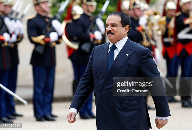 Bahrain's King Hamad bin Isa Al Khalifa walks past Republican Guards as he arrives before his meeting with French President Francois Hollande at the...