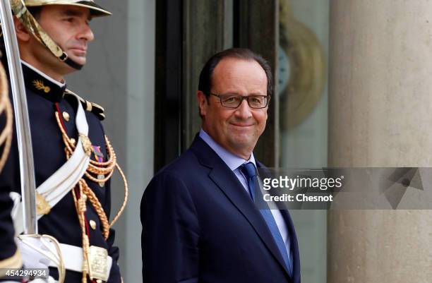 French President Francois Hollande waits before his meeting with Bahrain's King Hamad bin Isa Al Khalifa, at the Elysee Palace on August 28 in Paris,...