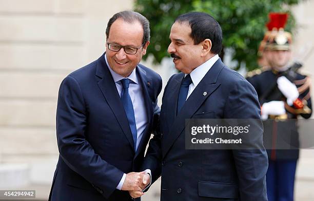 French President Francois Hollande welcomes Bahrain's King Hamad bin Isa al-Khalifa at the Elysee presidential Palace on August 28 in Paris, France.