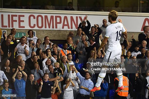 Tottenham Hotspur's English striker Harry Kane leaps into the air as he celebrates scoring the opening goal during the UEFA Europa League qualifying...