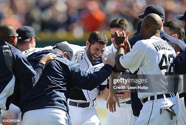 Alex Avila of the Detroit Tigers celebrates with his teammates after hitting a game-winning walk off single to left field in the bottom of the ninth...