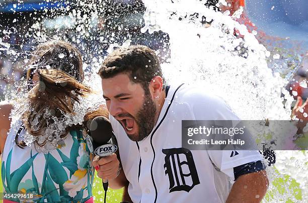 Alex Avila of the Detroit Tigers celebrates as his teammates dump the water bucket over his head after hitting the game game winning single to left...