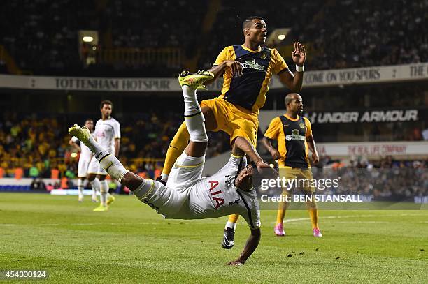 Tottenham Hotspur's Brazilian midfielder Paulinho falls to the ground after making an overhead shot on goal that is saved during the UEFA Europa...