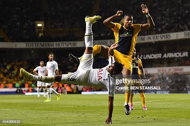 Tottenham Hotspur's Brazilian midfielder Paulinho falls to the ground after making an overhead shot on goal that is saved during the UEFA Europa...