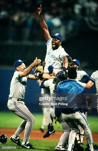 Joe Carter of the Toronto Blue Jays leaps in the air after the Blue Jays won World Series game two between the Atlanta Braves and Toronto Blue Jays...