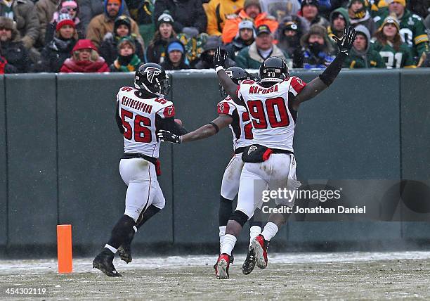 Sean Weatherspoon of the Atlanta Falcons crosses the goalline with teammates including Stansly Maponga after intercepting a pass for a touchdown...