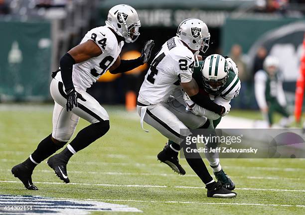Kevin Burnett Charles Woodson of the Oakland Raiders coverage on Jeremy Kerley of the New York Jets during their game at MetLife Stadium on December...