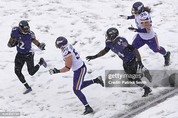 Jacoby Jones of the Baltimore Ravens returns a punt in the second quarter against the Minnesota Vikings at M&T Bank Stadium on December 8, 2013 in...